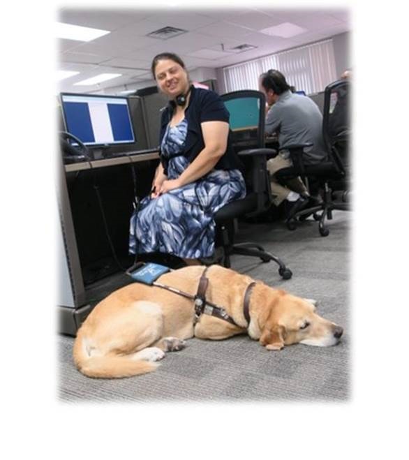 Katie and her guide dog, Charlie, pre-pandemic in a call center